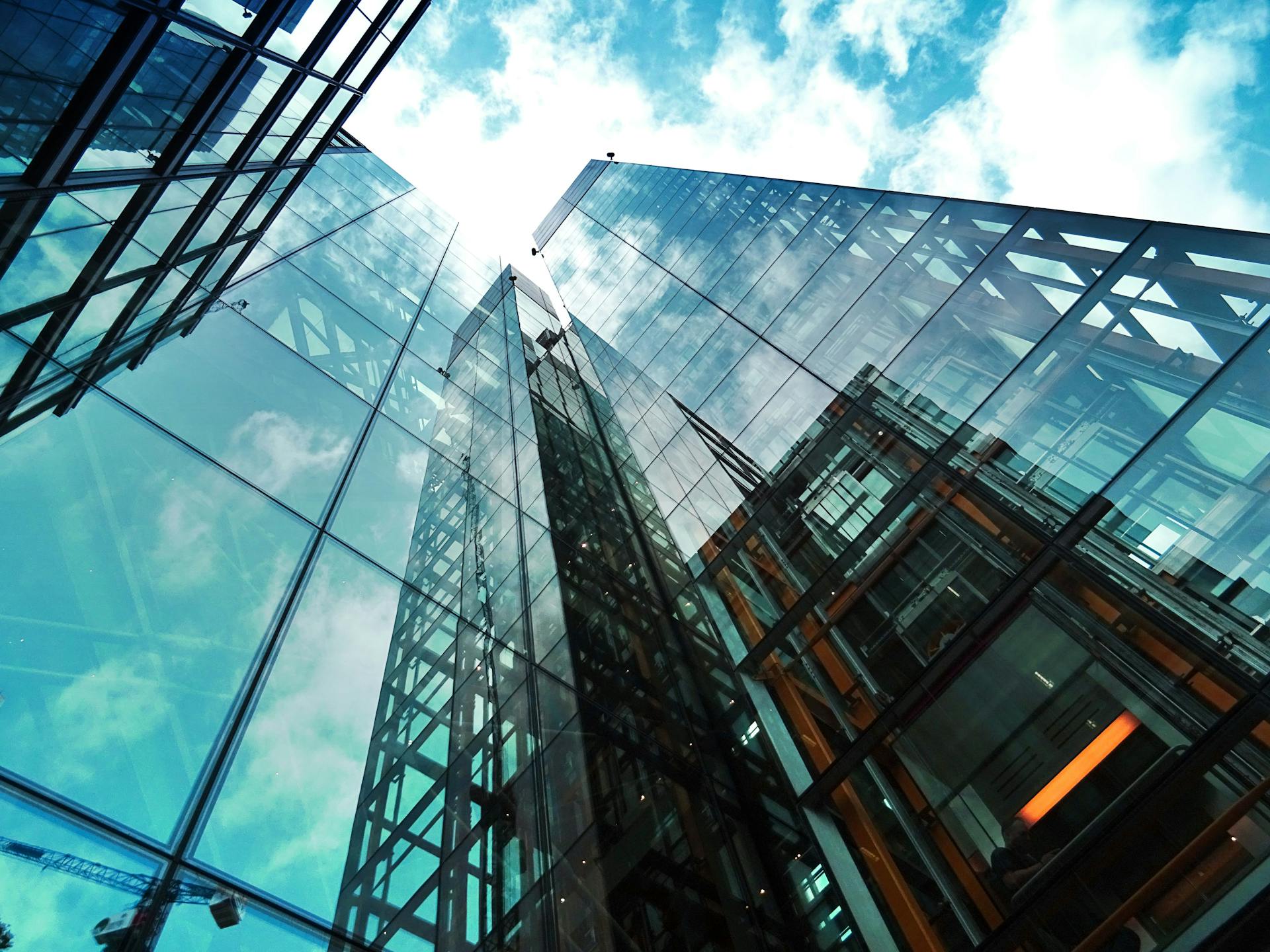 Modern glass buildings reflecting sky
