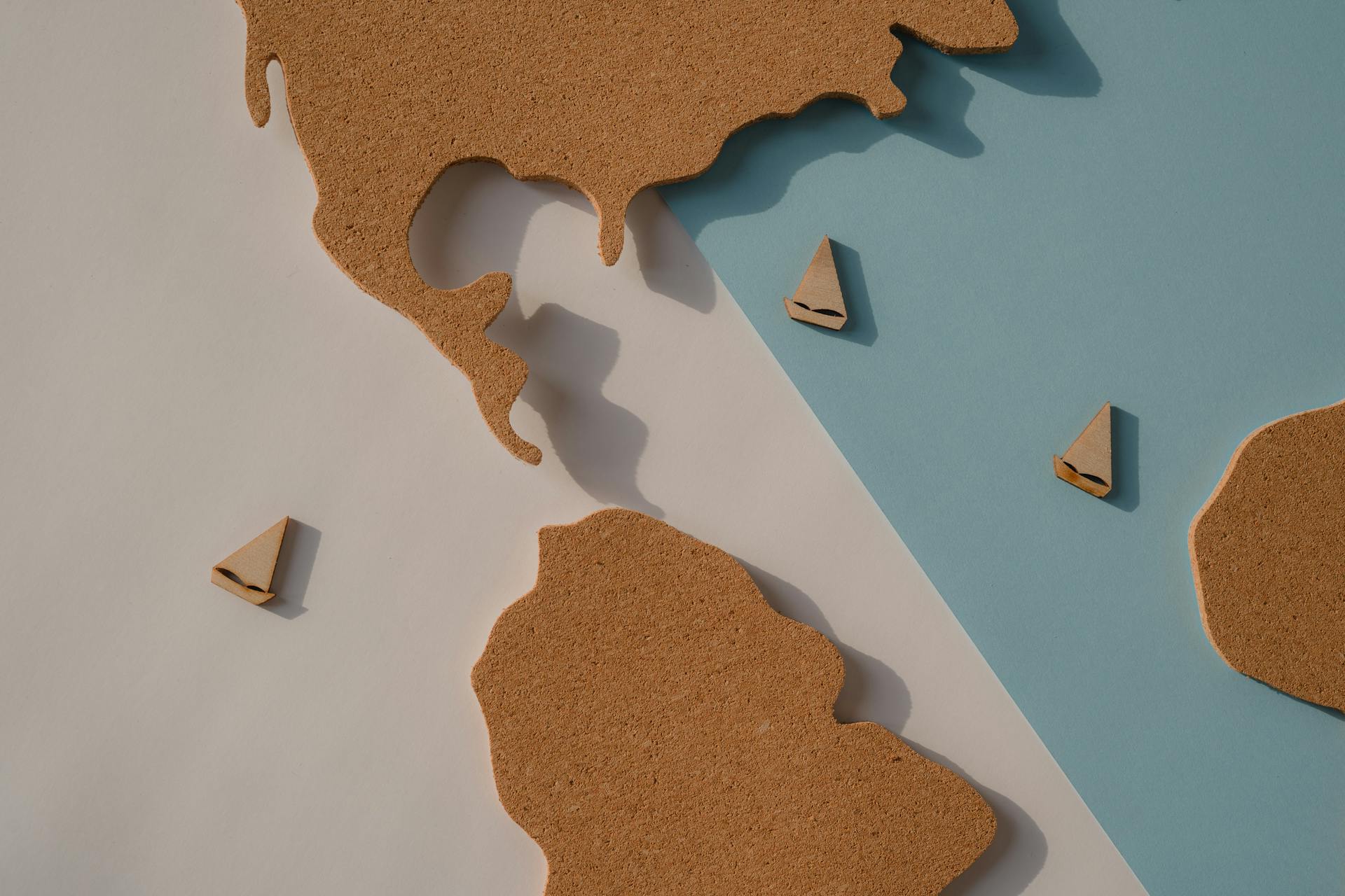Stylized map with cork landmasses and wooden boats